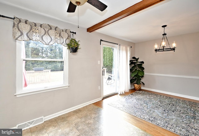 entryway with ceiling fan with notable chandelier, beamed ceiling, visible vents, and baseboards