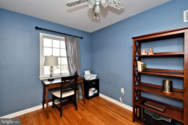 office area featuring visible vents, ceiling fan, baseboards, and wood finished floors