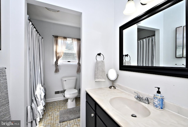 bathroom with toilet, baseboards, visible vents, and vanity