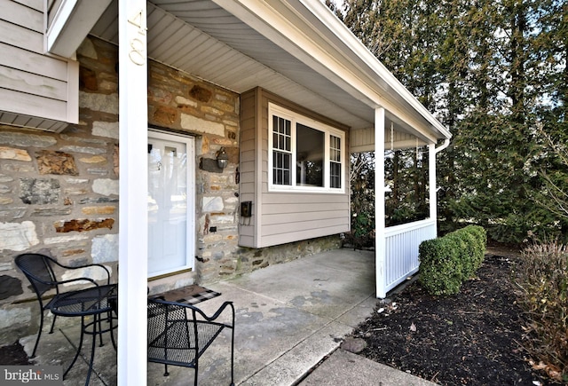 view of exterior entry featuring stone siding