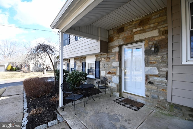 property entrance with stone siding