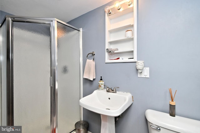 bathroom with a shower stall and toilet