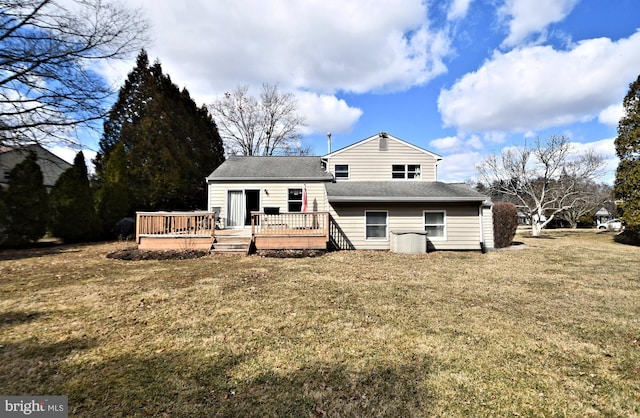 back of house featuring a yard, roof with shingles, and a wooden deck