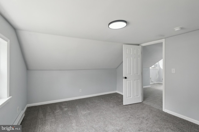 bonus room with carpet floors, vaulted ceiling, and baseboards