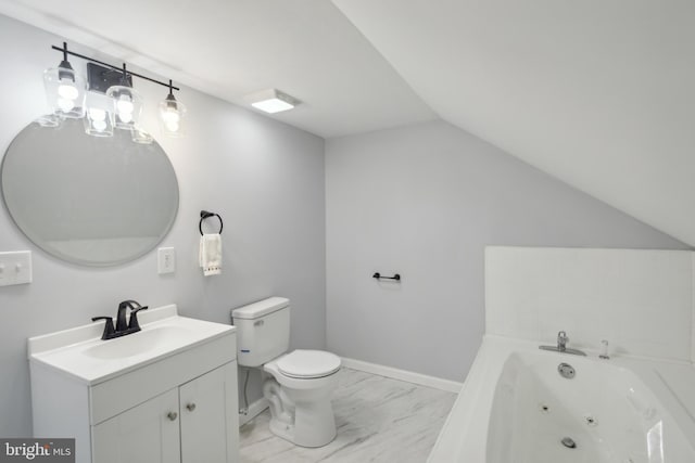 bathroom with marble finish floor, toilet, vaulted ceiling, vanity, and a jetted tub