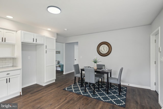 dining room featuring dark wood-type flooring, recessed lighting, and baseboards