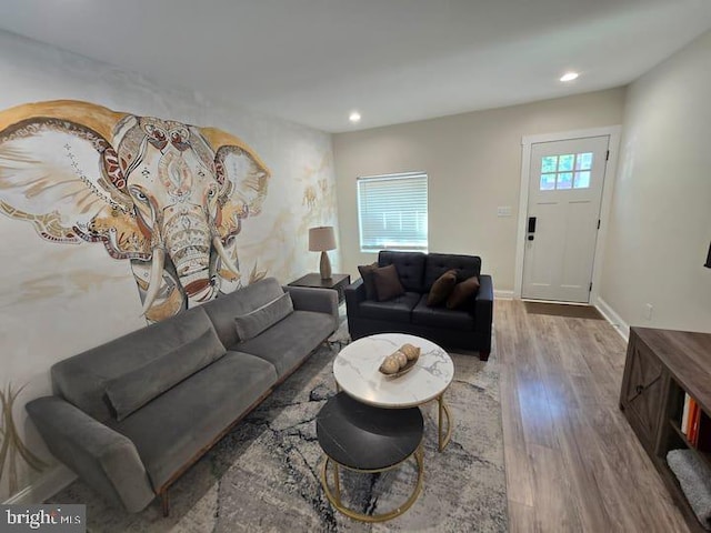 living room with recessed lighting, baseboards, and wood finished floors