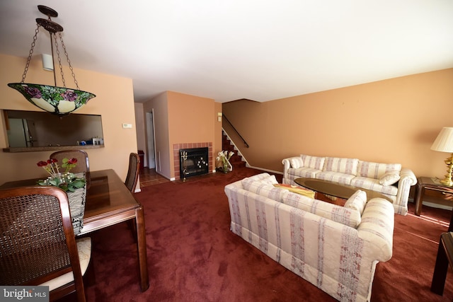 carpeted living area with stairway and a tiled fireplace