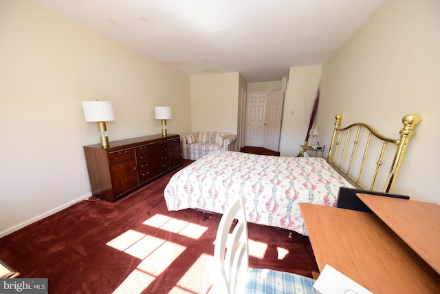 bedroom featuring baseboards and dark carpet