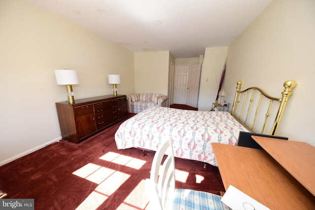 bedroom featuring baseboards and dark colored carpet