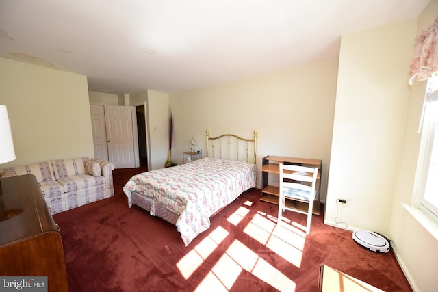 carpeted bedroom with baseboards