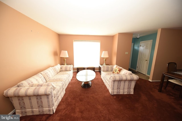 carpeted living room with baseboards