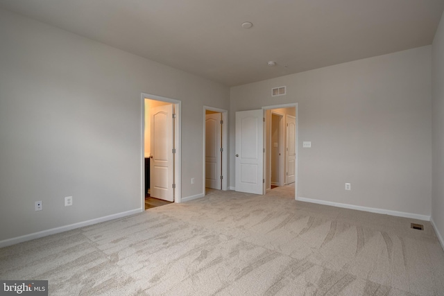 unfurnished bedroom featuring baseboards, visible vents, and carpet flooring