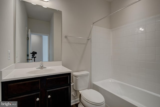 bathroom featuring  shower combination, vanity, and toilet