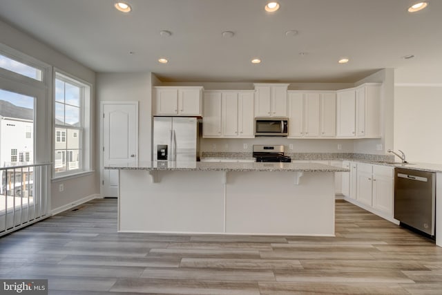 kitchen with white cabinets, stainless steel appliances, and recessed lighting