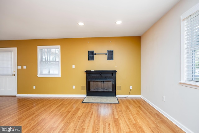 2115 Ruxton Dr, Salisbury, MD 21801 - unfurnished living room featuring a glass covered fireplace, light wood-type flooring, recessed lighting, and baseboards