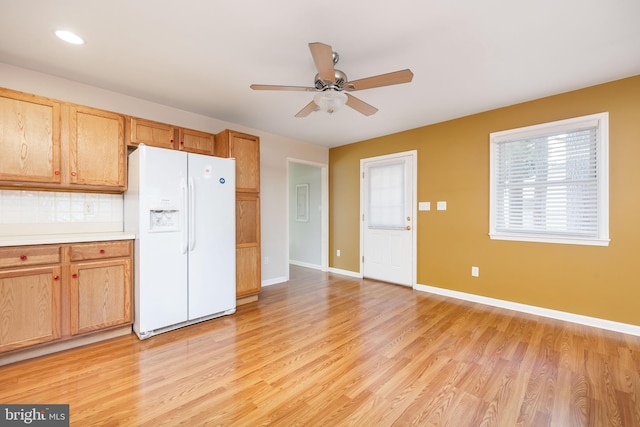 2115 Ruxton Dr, Salisbury, MD 21801 - kitchen with white refrigerator with ice dispenser, light wood finished floors, baseboards, ceiling fan, and light countertops