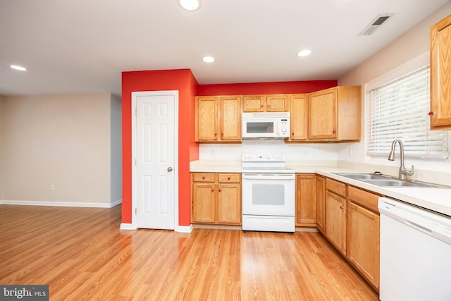 2115 Ruxton Dr, Salisbury, MD 21801 - kitchen featuring white appliances, a sink, light wood-style flooring, light countertops, and baseboards