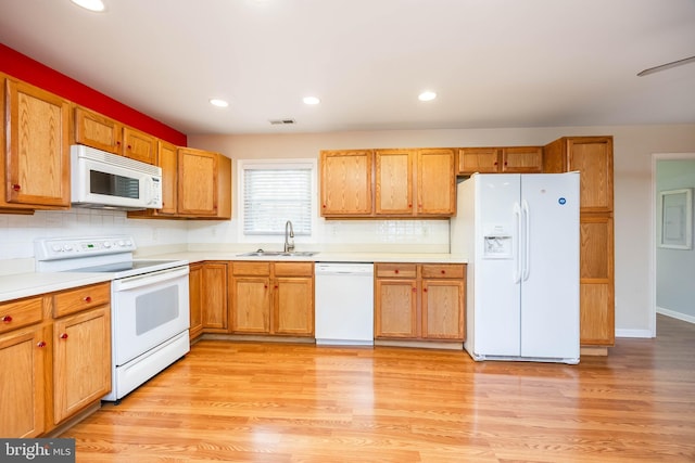2115 Ruxton Dr, Salisbury, MD 21801 - kitchen with white appliances, a sink, decorative backsplash, light countertops, and light wood-type flooring