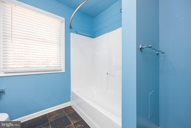 2115 Ruxton Dr, Salisbury, MD 21801 - full bath with baseboards, stone tile floors, toilet, and  shower combination