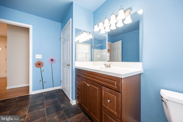 2115 Ruxton Dr, Salisbury, MD 21801 - bathroom with baseboards, toilet, a shower, vanity, and stone finish floors