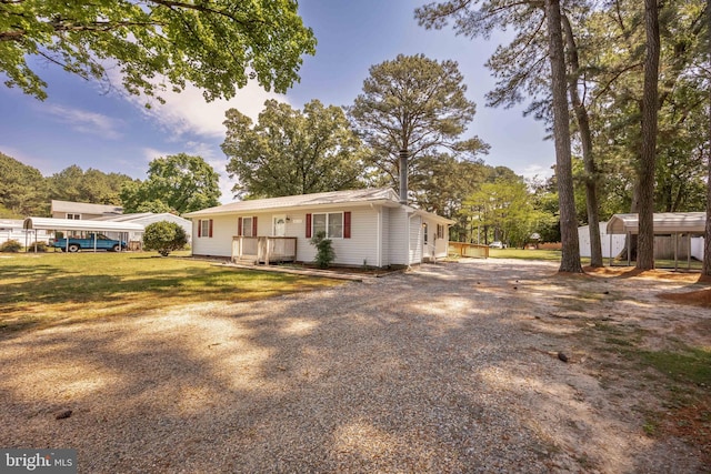 2115 Ruxton Dr, Salisbury, MD 21801 - view of front of house featuring a storage shed, an outdoor structure, and gravel driveway