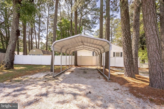 2115 Ruxton Dr, Salisbury, MD 21801 - view of vehicle parking with a carport, fence, and gravel driveway