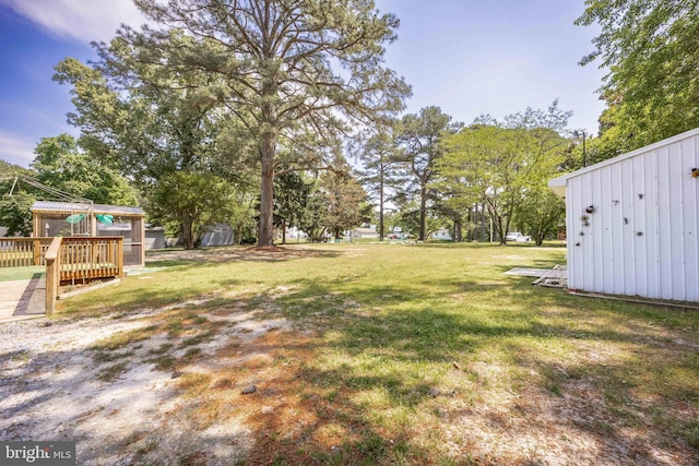 2115 Ruxton Dr, Salisbury, MD 21801 - view of grassy yard featuring a deck and an outbuilding