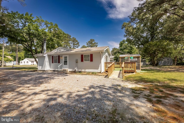 2115 Ruxton Dr, Salisbury, MD 21801 - bungalow-style house featuring a deck, entry steps, a storage shed, and an outbuilding