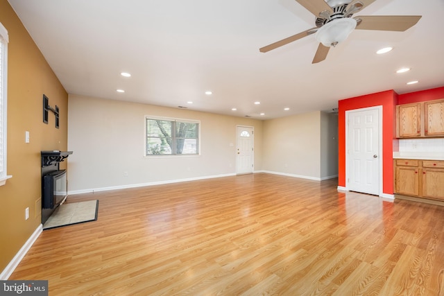 2115 Ruxton Dr, Salisbury, MD 21801 - unfurnished living room with recessed lighting, light wood-style flooring, baseboards, ceiling fan, and a wood stove