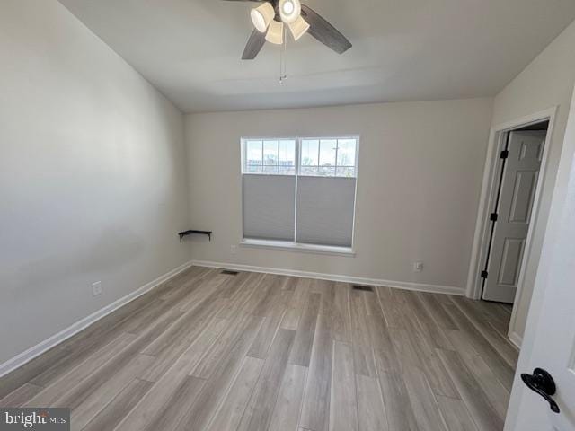 unfurnished room featuring a ceiling fan, baseboards, and wood finished floors