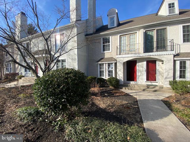 view of property with a balcony and stucco siding