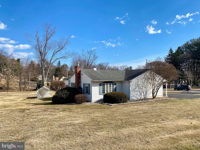 view of home's exterior with a lawn and a chimney