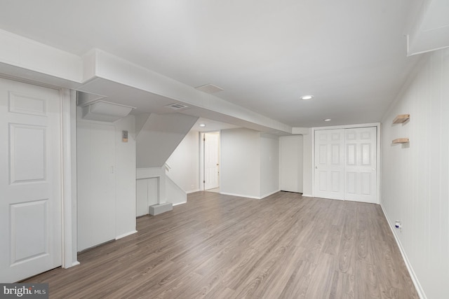 finished below grade area featuring baseboards, wood finished floors, and recessed lighting