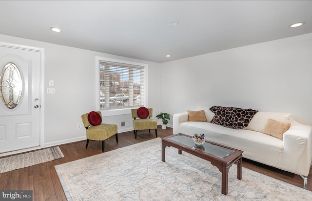 living area with recessed lighting, visible vents, baseboards, and wood finished floors