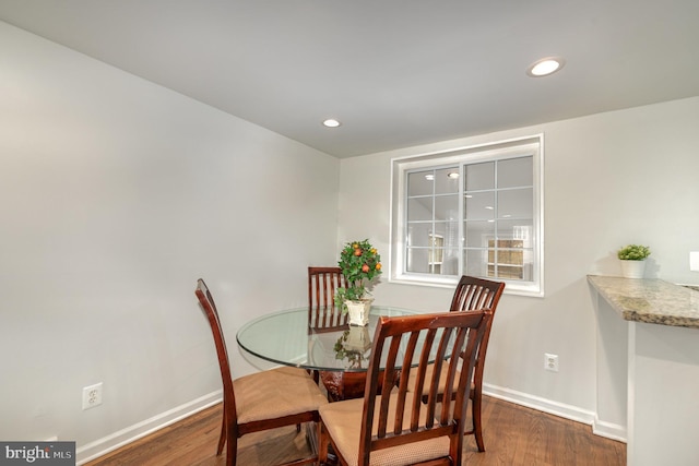 dining space featuring recessed lighting, baseboards, and wood finished floors