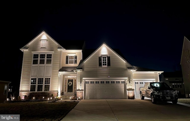 traditional-style home with stone siding, driveway, and a garage