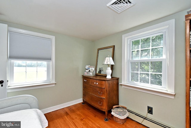 1200 Branch Rd, Perkasie, PA 18944 - living area with a baseboard heating unit, plenty of natural light, and wood finished floors