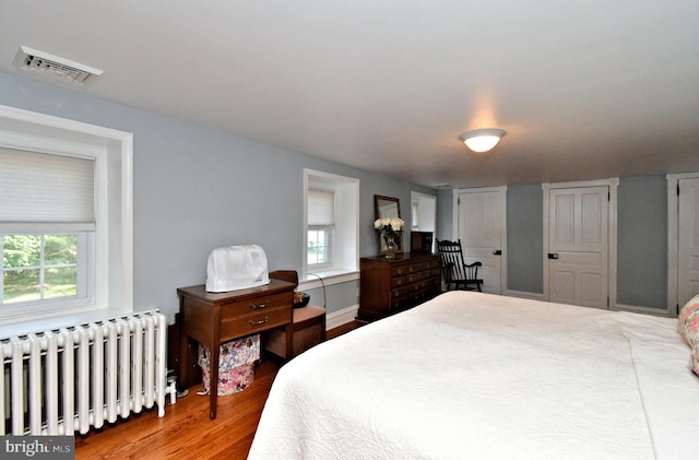 1200 Branch Rd, Perkasie, PA 18944 - bedroom with radiator, multiple windows, and wood finished floors