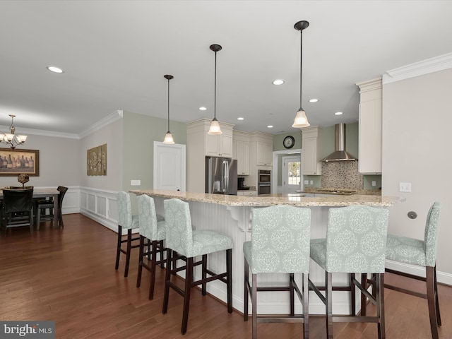 kitchen featuring dark wood-style floors, stainless steel appliances, wall chimney exhaust hood, crown molding, and light stone countertops