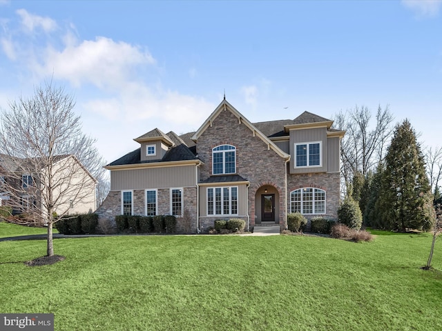 view of front of property featuring stone siding and a front lawn