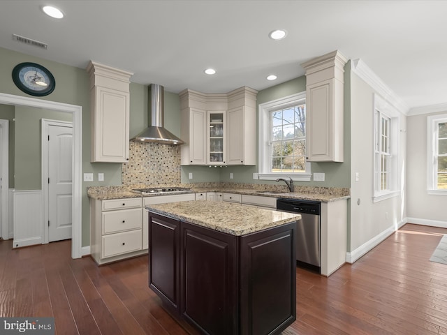 kitchen with visible vents, light stone countertops, appliances with stainless steel finishes, dark wood-style floors, and wall chimney exhaust hood