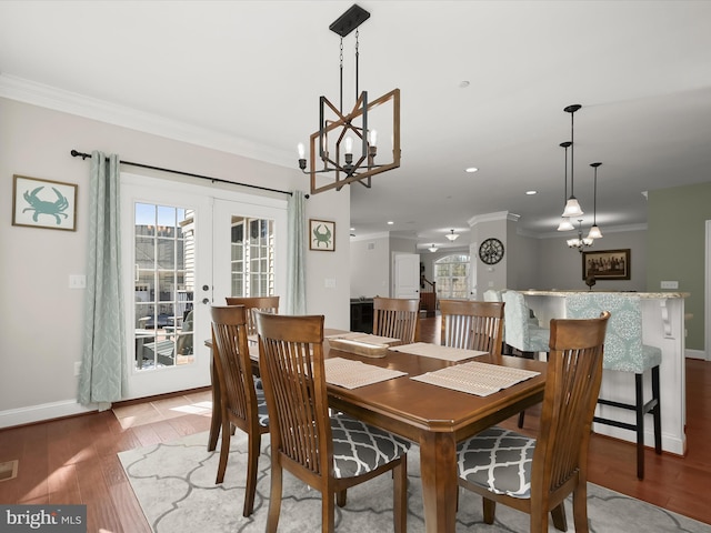 dining room featuring baseboards, recessed lighting, ornamental molding, french doors, and light wood-style floors