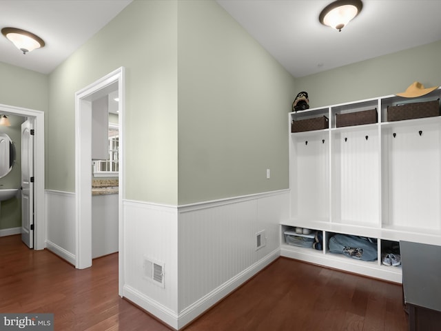 mudroom featuring visible vents, wood finished floors, and a wainscoted wall