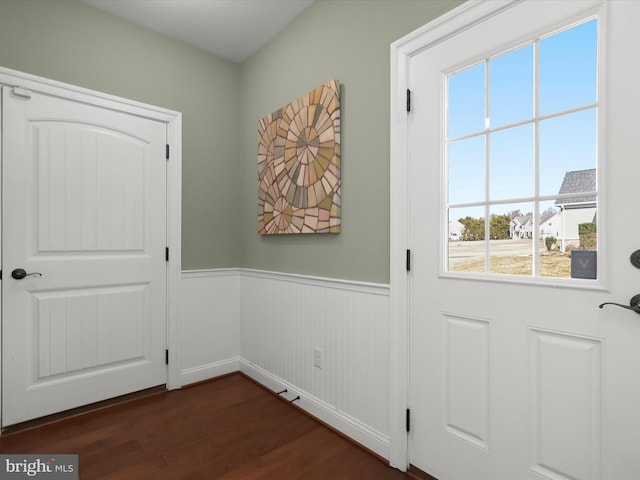 entryway featuring a wainscoted wall and dark wood-style floors