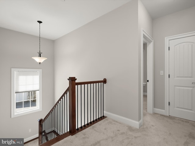 stairs with baseboards and carpet floors