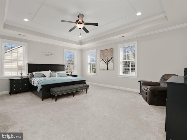 bedroom featuring multiple windows, baseboards, and a tray ceiling