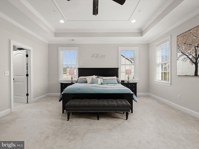 bedroom with ornamental molding, baseboards, a tray ceiling, and carpet floors