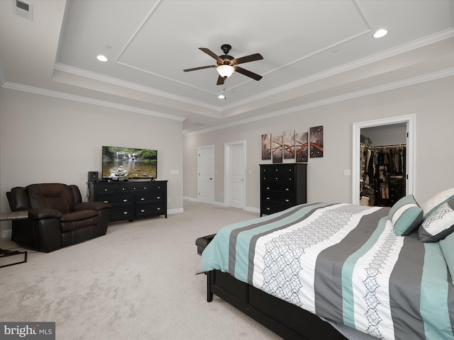 bedroom with visible vents, light colored carpet, crown molding, and a tray ceiling