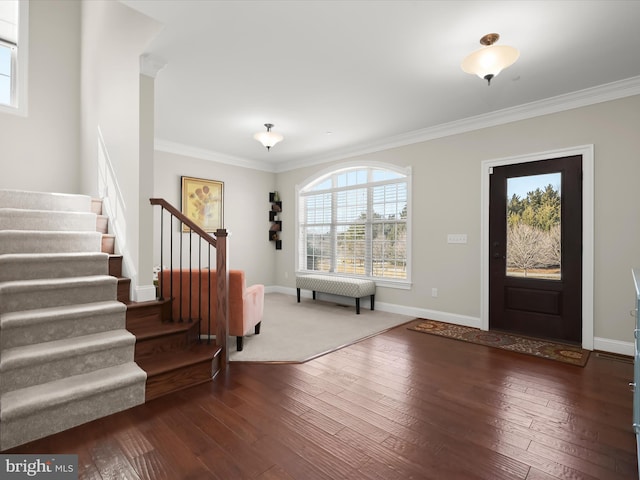 entryway with hardwood / wood-style floors, stairway, baseboards, and ornamental molding